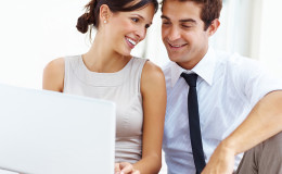 Young business couple working on laptop